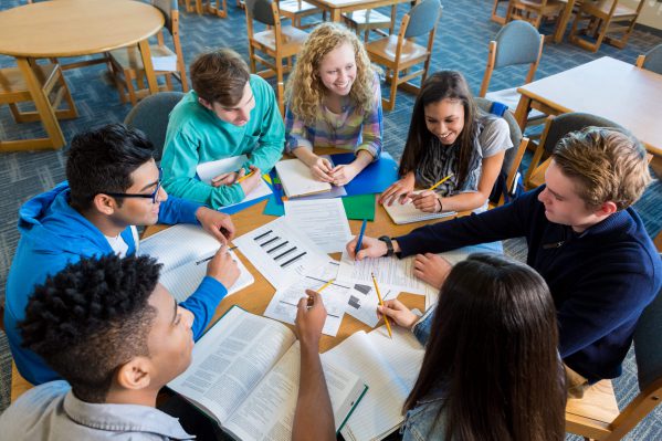 An image of a group of students seated at a circular table in a study group.