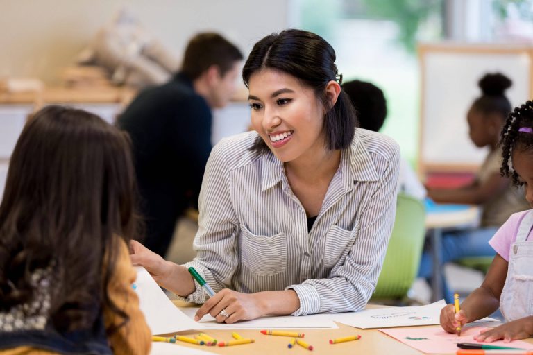 A teacher complimenting her student on her drawing.