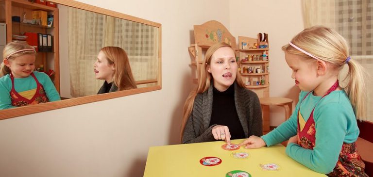 A speech therapist practicing pronunciation with her patient.