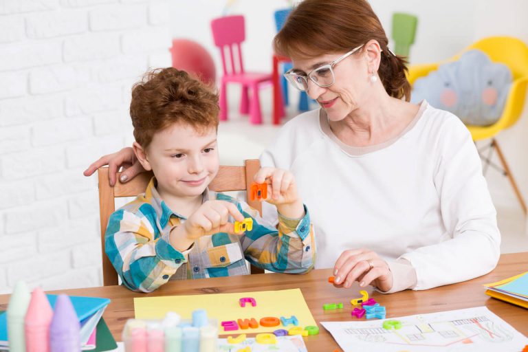 An occupational therapist helping their patient with fine motor skills.