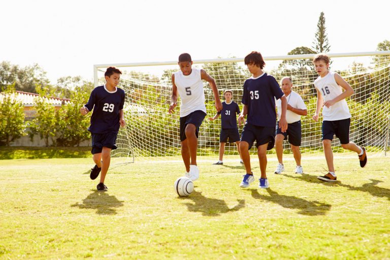 A soccer team practicing together on the field.