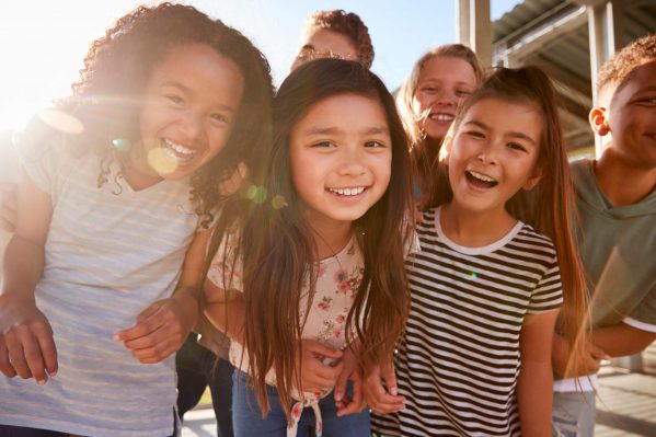 A group of students gathered and smiling at the camera.
