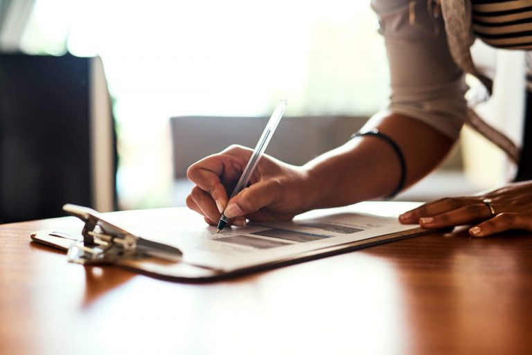 A nurse checking of a list attached to a clipboard.