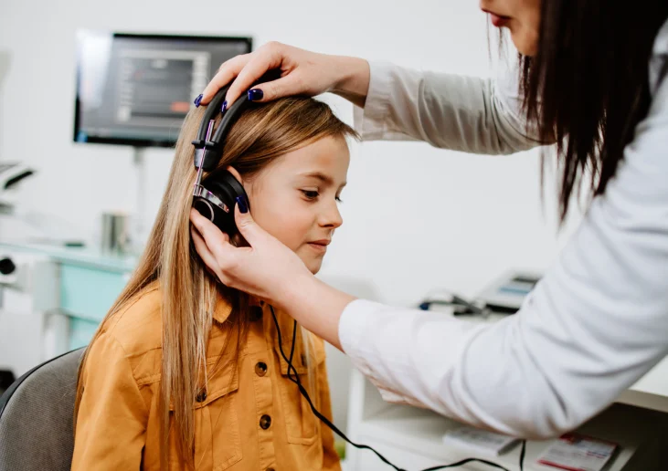 Audiologist with hard-of hearing-student.