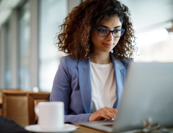 Teacher writing resume on laptop
